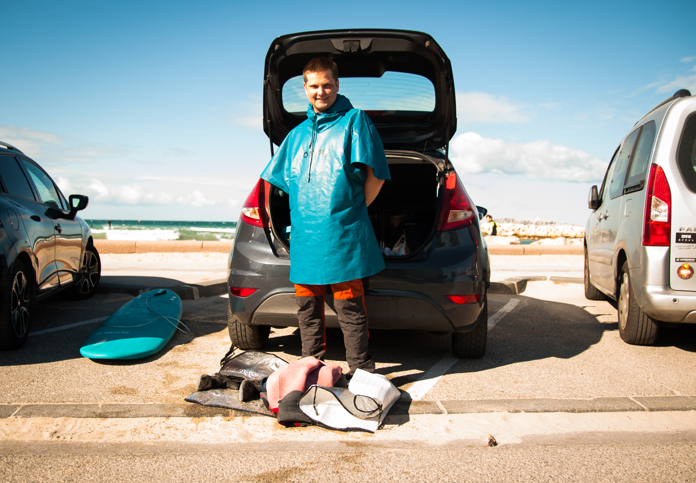 HUVEAUNE BEACH, Marseille – Man standing in front of his car trunk with his surfing equipment at his feet.