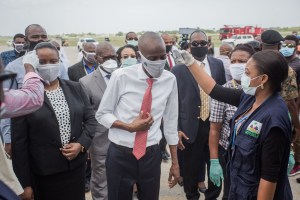 Haitian President Jovenel Moise (C), his wife Martine (L) have their temperature taken on arrival at Haiti's airport in Port-au-Prince on May 7, 2020. Haiti still has no COVID vaccines.