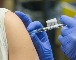 doctor administers pfizer vaccine