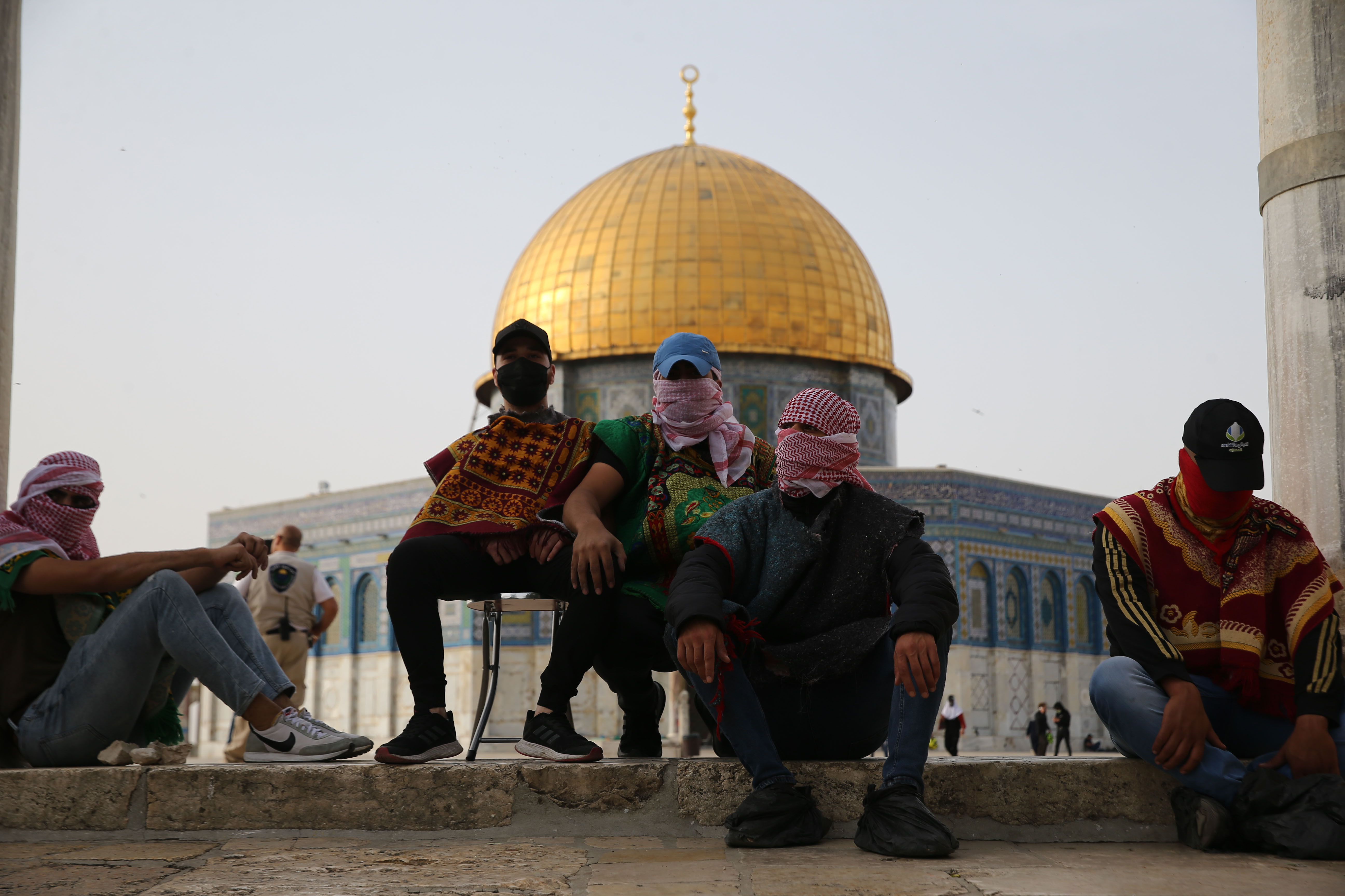 Palestinians wait at the entrance to the al-Aqsa Mosque compound. Photo: Mostafa Alkharouf/Anadolu Agency via Getty Images