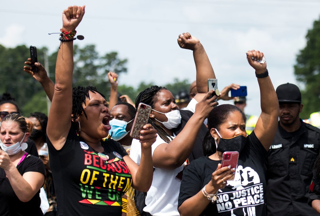 Members of the crowd cheer when a group of black motorcyclists circled the street outside a memorial and public viewing for George Floyd on June 6, 2020 in Fayetteville, North Carolina. (Melissa Sue Gerrits/Getty Images)