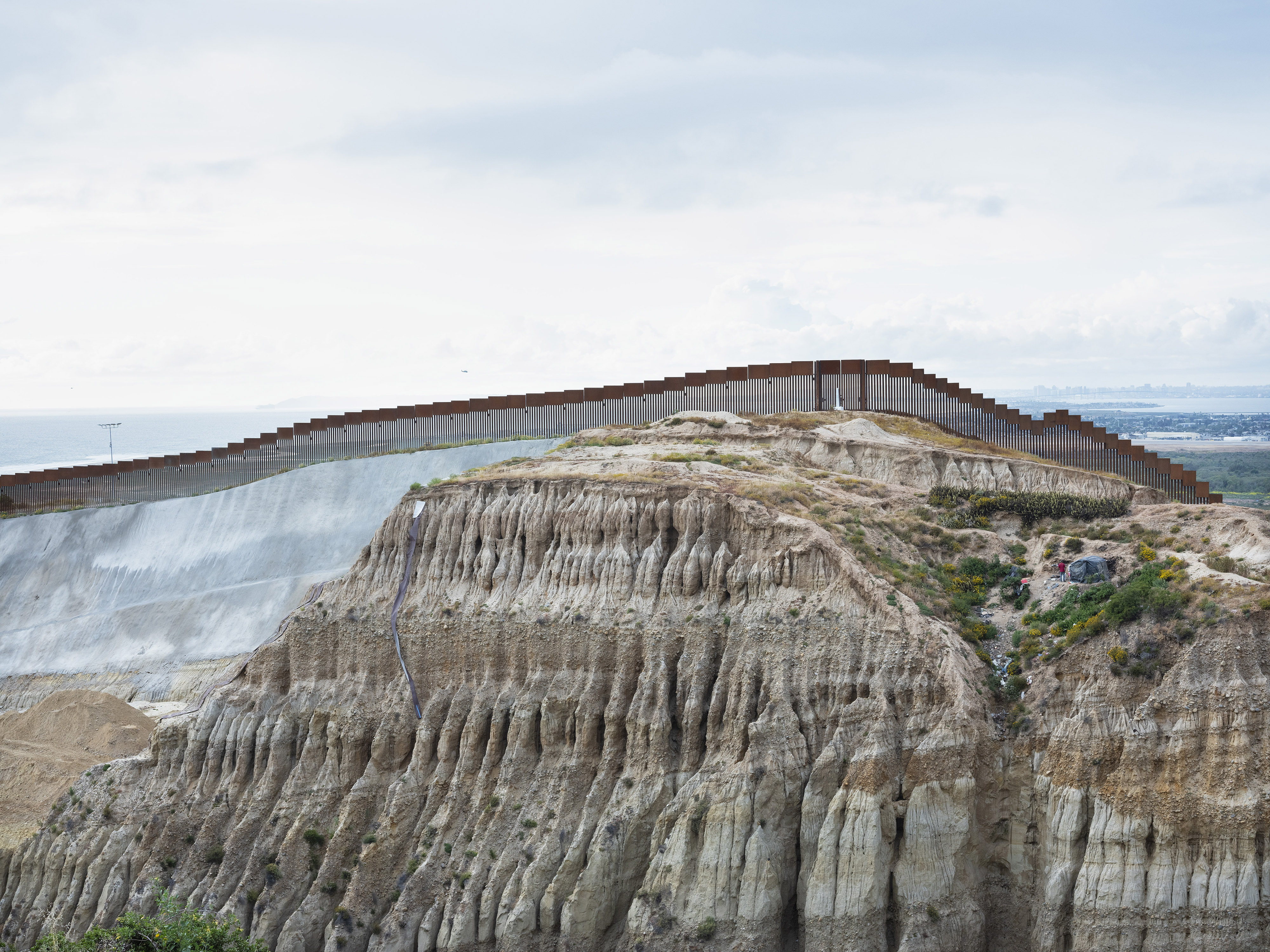 Rafal Milach's photo of an improvised shelter by the Mexican-US border wall