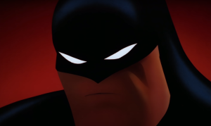 Batman in his cowl, scowling.