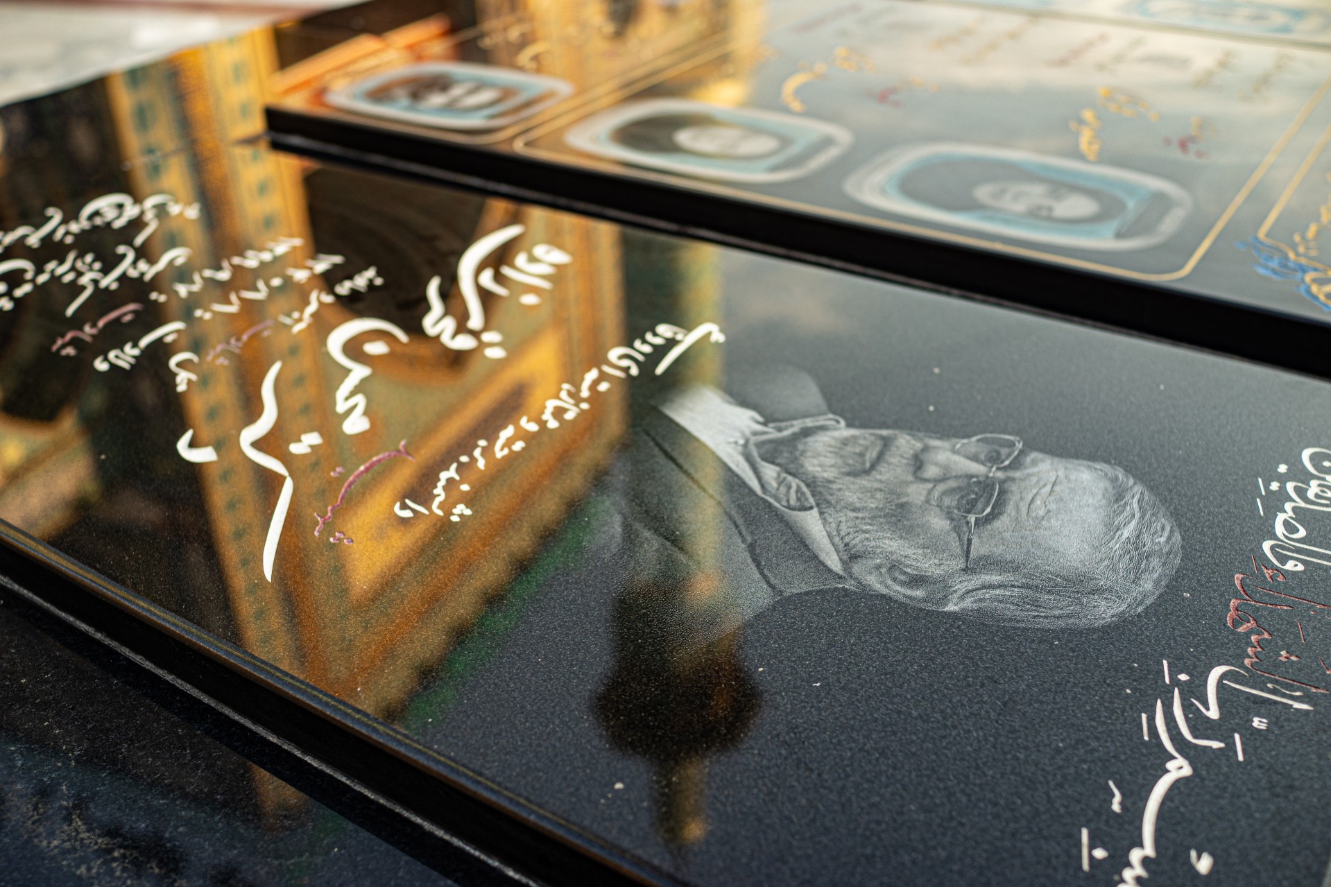 Fakhrizadeh's monument with the mosque reflected in the background.
