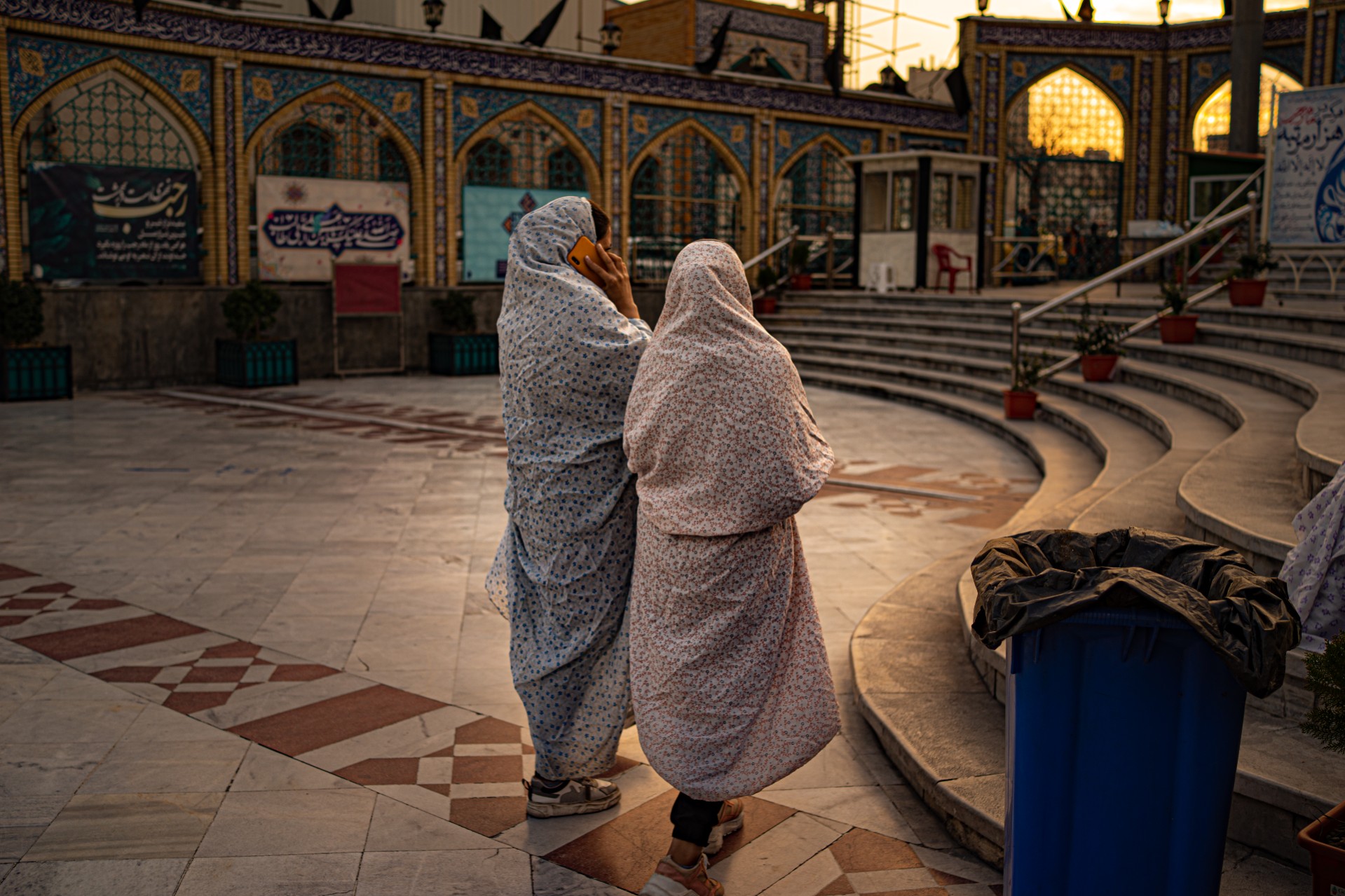 Women hanging at the mosque. Women not in full head to toe coverings have to grab one of these at the entrance.