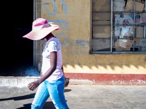 File photo of pedestrians walking past a food shop in the central Zimbabwean town of Kadoma.