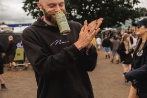 Download Festival attendee wiping his hands clean with anti-bacterial gel