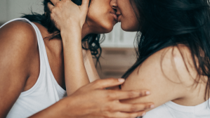 Two women kissing - stock photo