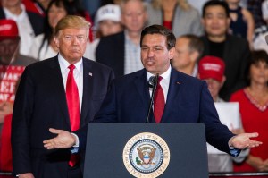 Florida Republican gubernatorial candidate Ron DeSantis speaks with U.S. President Donald Trump at a campaign rally at the Pensacola International Airport on November 3, 2018 in Pensacola, Florida. President Trump is campaigning in support of Republican c