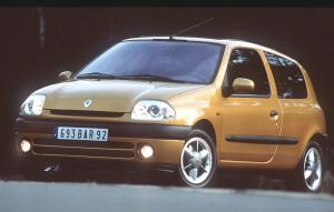 Yellow-gold small utilitarian car parked on the street with lights on