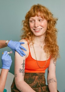 Woman receiving a shot in her upper arm
