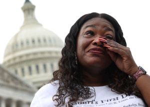U.S. Rep Cori Bush wiping tears from her eyes