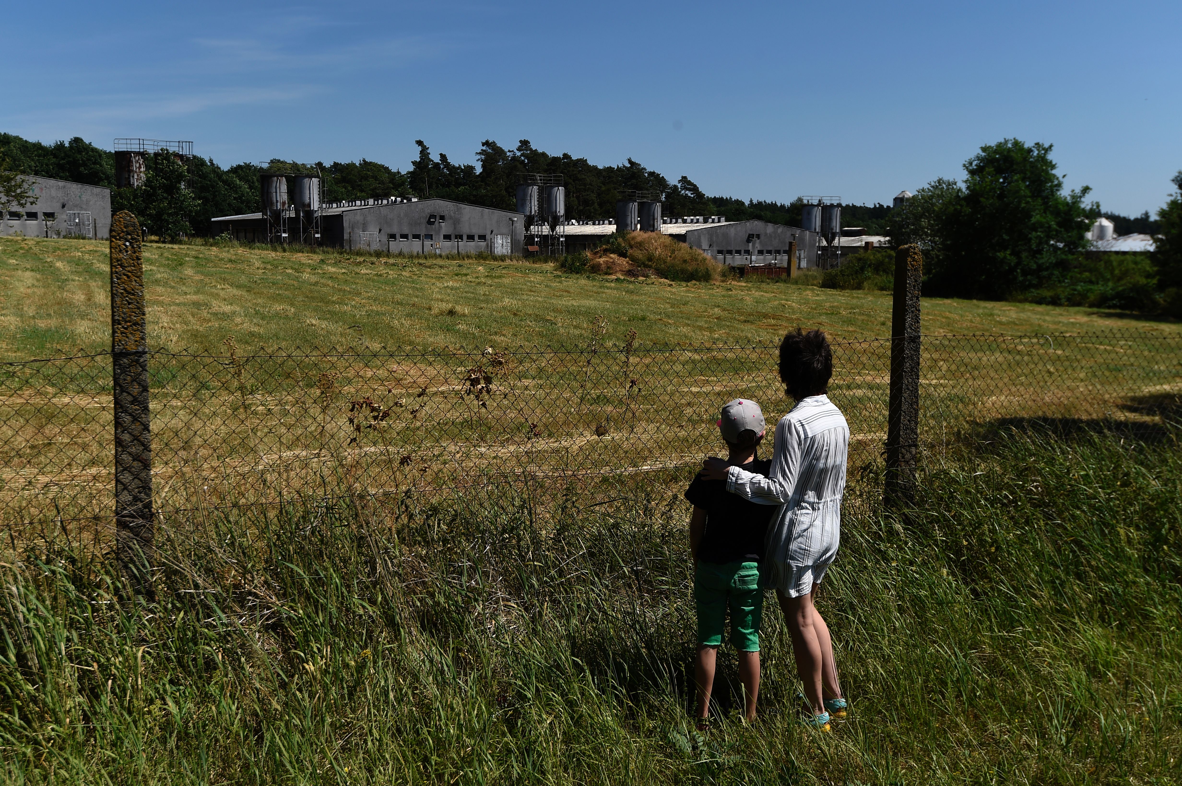 A woman and child look on at the site of a former concentration camp in Lety, Czech Republic, that housed Roma people during the Second World War. Photo: MICHAL CIZEK/AFP via Getty Images