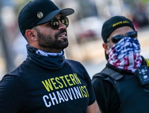 Chairman of the Proud Boys Enrique Tarrio (L) looks on while counter-protesting near the Torch of Friendship, where people gathered to remember George Floyd on the one-year anniversary of his murder at the hands of a police officer, in Miami on May 25, 20