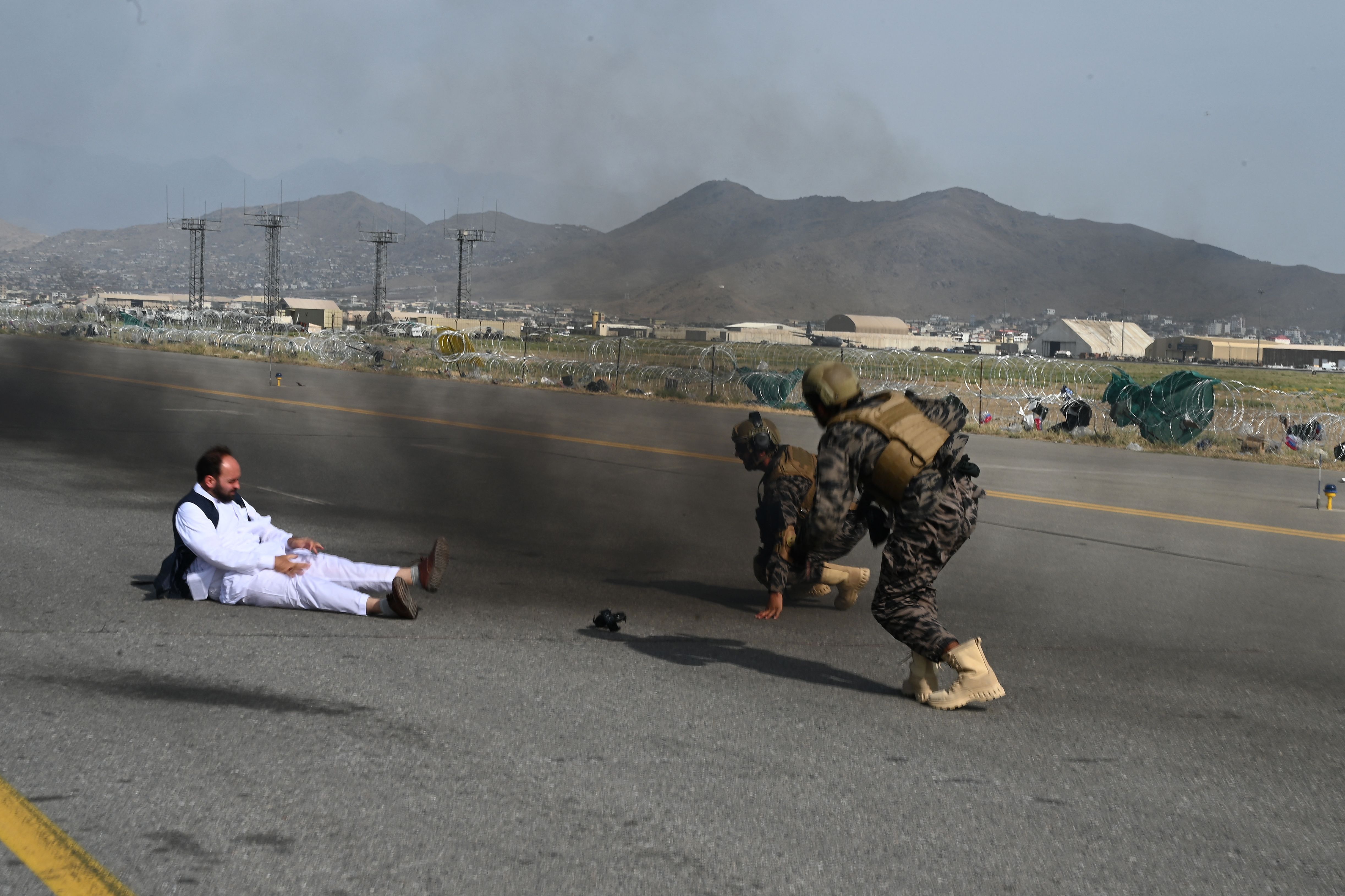 The Taliban's Badri special force fighters and a journalist get up after falling from a vehicle at Kabul's airport at the end of August, after the US withdrew all troops from the country. Photo: WAKIL KOHSAR/AFP via Getty Images
