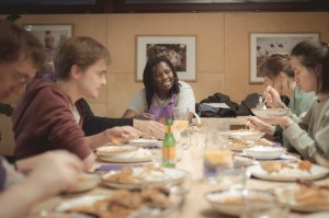 Awa Sanneh sitting down to eat with the cooking class in London. Photo: Courtesy of Jessy Amr.