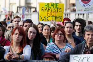Women hold banners as they take part in a "slut walk" in London on September 22, 2012 to protest against the police and courts' denial of justice for rape victims.
