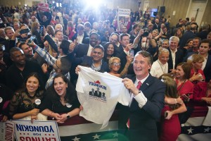 Glenn Youngkin, governor-elect of Virginia, holds a campaign t-shirt while greeting attendees after speaking during an election night event in Chantilly, Virginia, U.S., on Wednesday, Nov. 3, 2021.