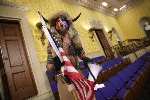 Jacob Chansley screams "Freedom" inside the Senate chamber after the U.S. Capitol was breached by a mob during a joint session of Congress on January 06, 2021 in Washington, DC. (Win McNamee/Getty Images)