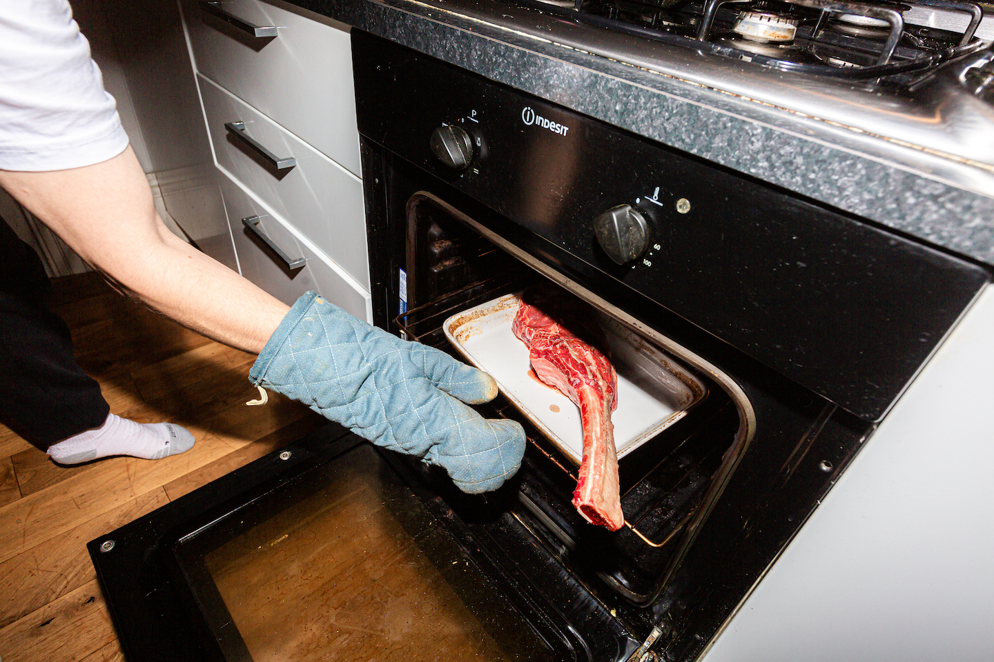 The author putting a steak into the oven
