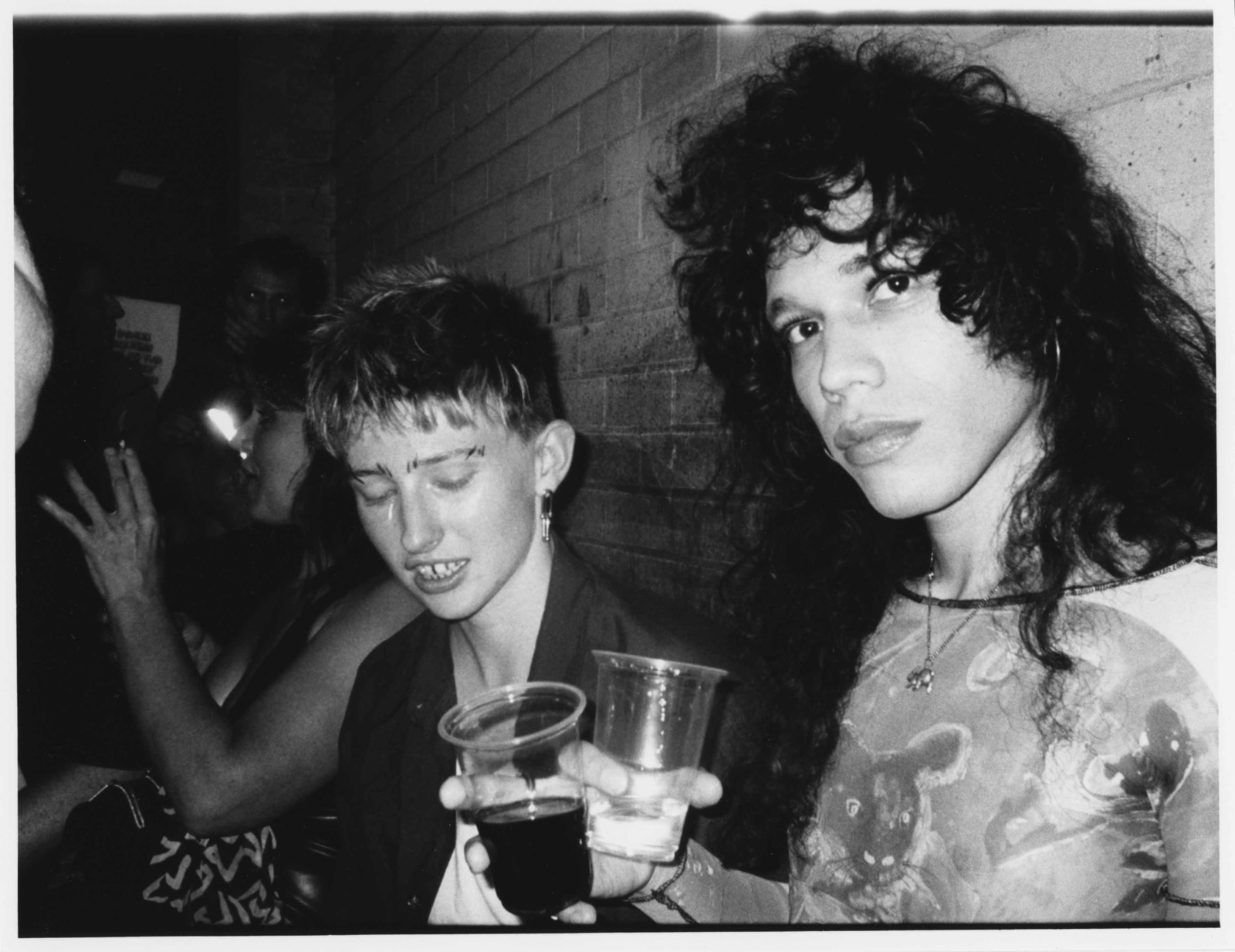 Clubbers at Big Dyke Energy holding drinks in plastic cups