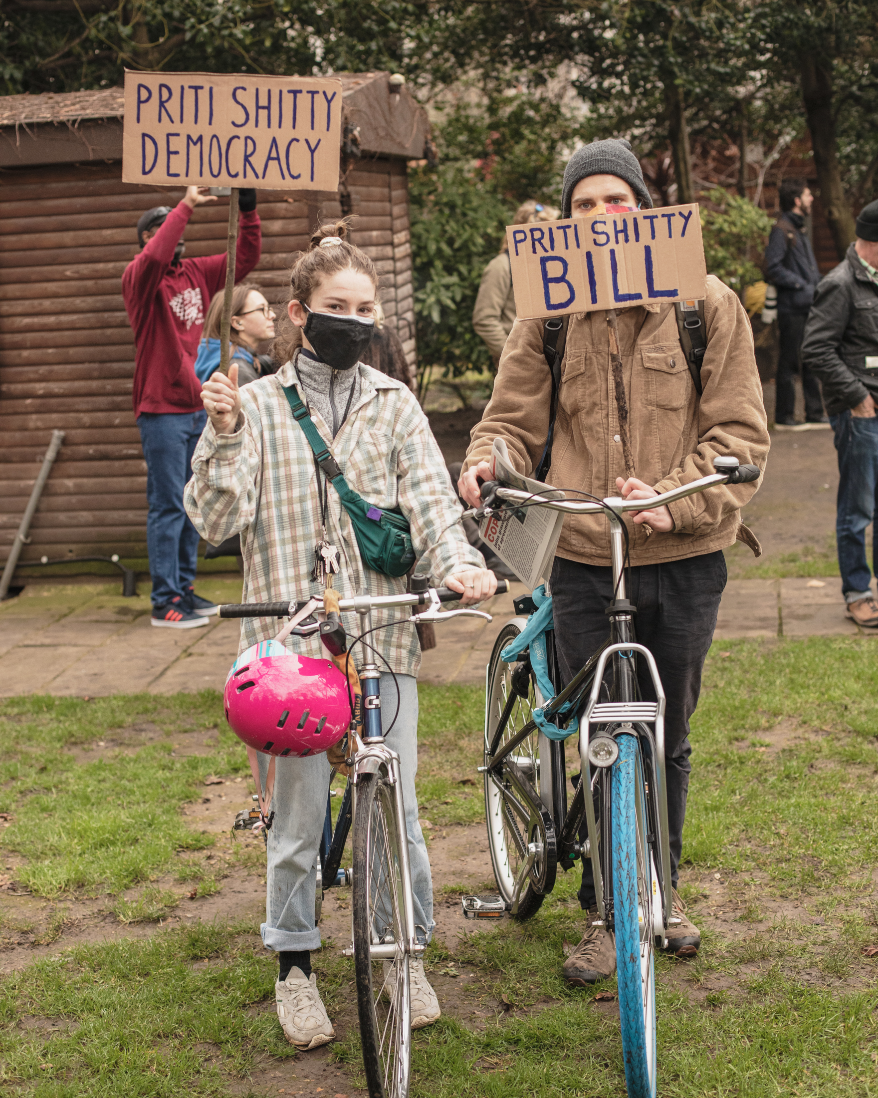 Kill the Bill protesters Louise and Jacint holding up anti-Priti Patel protest signs.