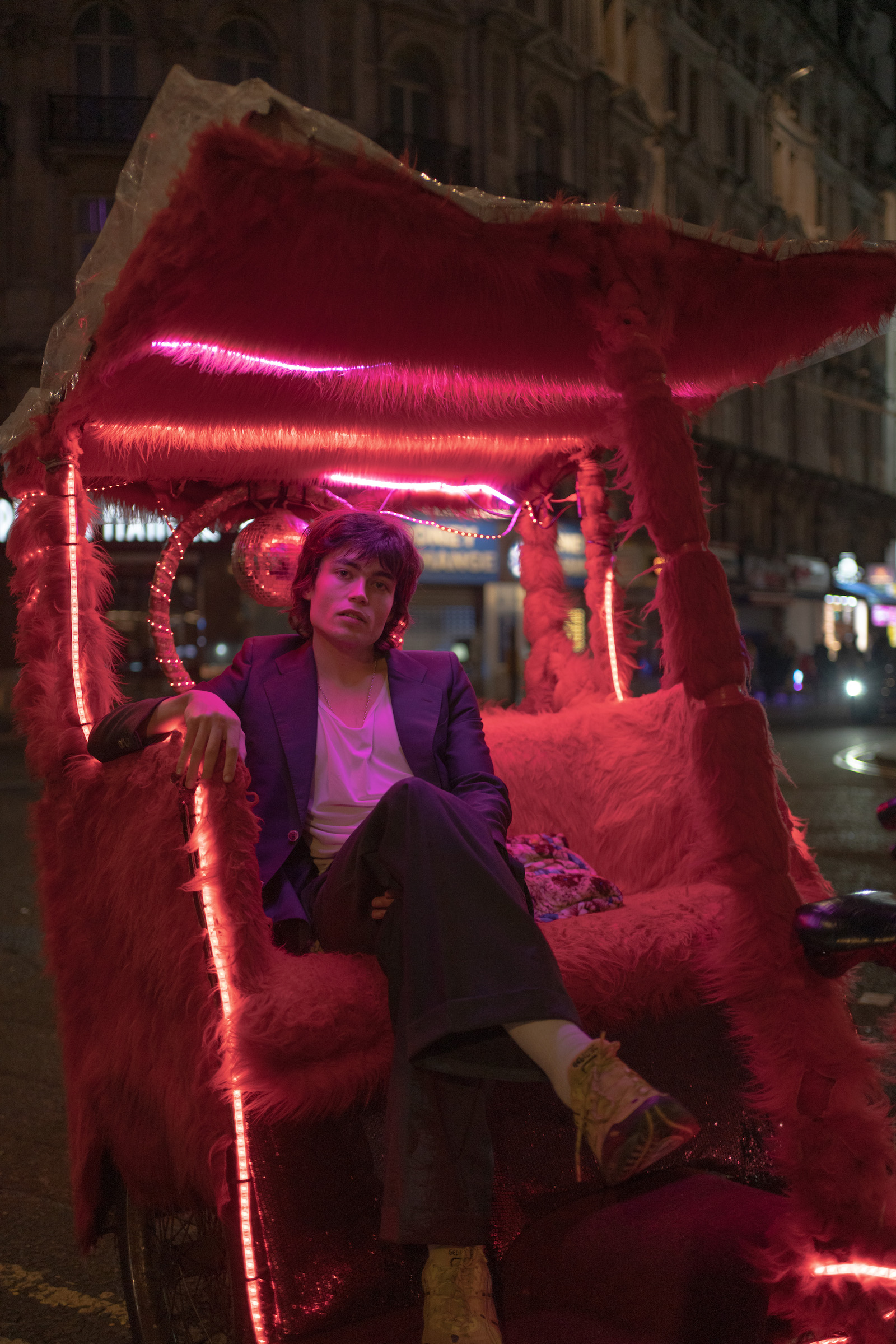 Jake on a rickshaw in Soho at night