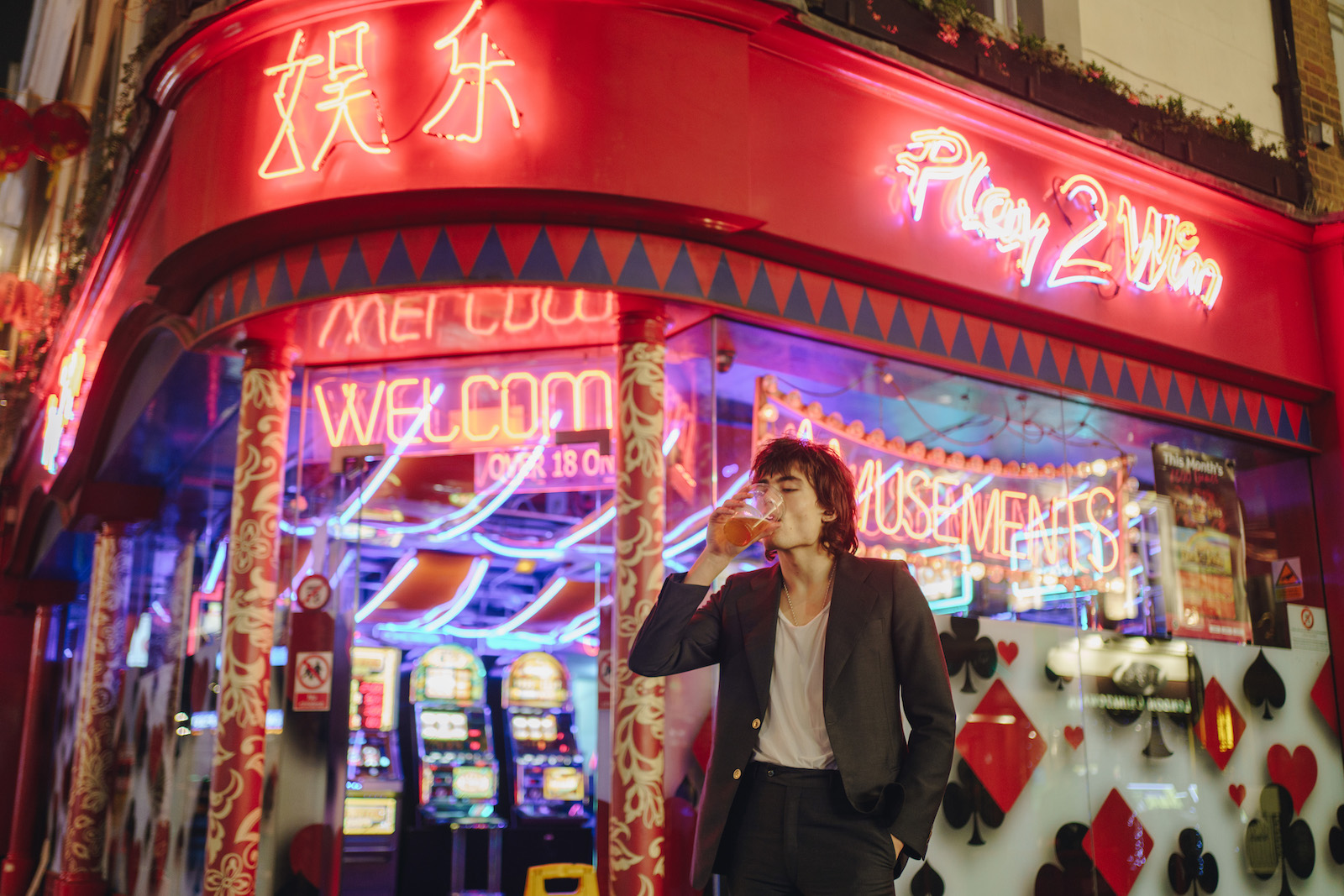 Jake drinking a pint outside 24-hour Casino 'Play2win' in Soho