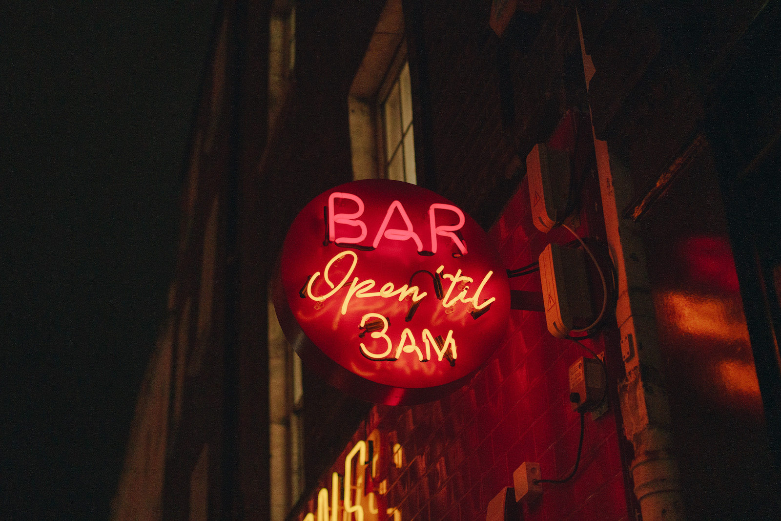 Neon bar sign reading 'Open 'til 3AM'