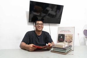 Om Hao di kantor Kisah Tanah Jawa sedang memamerkan buku-buku untuk riset sejarahnya_ Photo by Alfian Widi