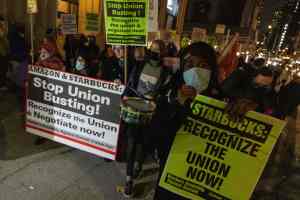 Starbucks workers march in support of unionization.