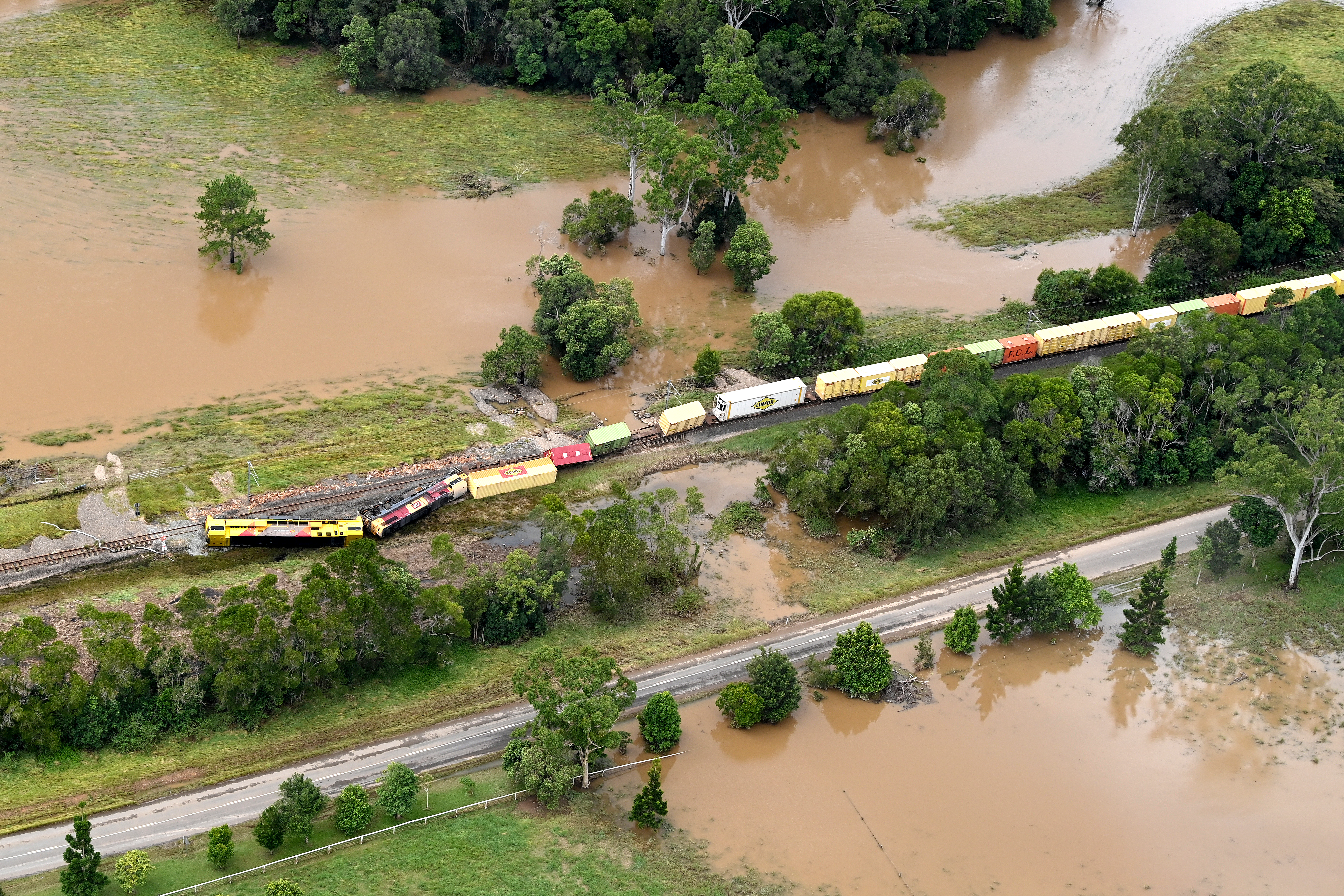 In an aerial view, a train is derailed in an accident caused by flooding in the town of Gympie, an area north of Sunshine Coast, Australia. Parts of South-East Queensland are experiencing the worst flooding in over a decade. Image: Bradley Kanaris/Getty Images