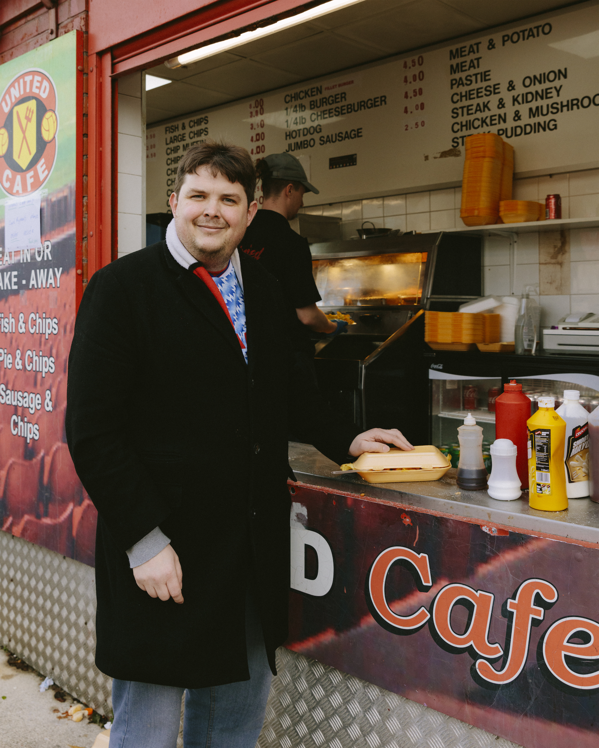 Manchester United fan James Coatsworth standing with a takeaway.