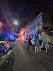 A street with a house on fire