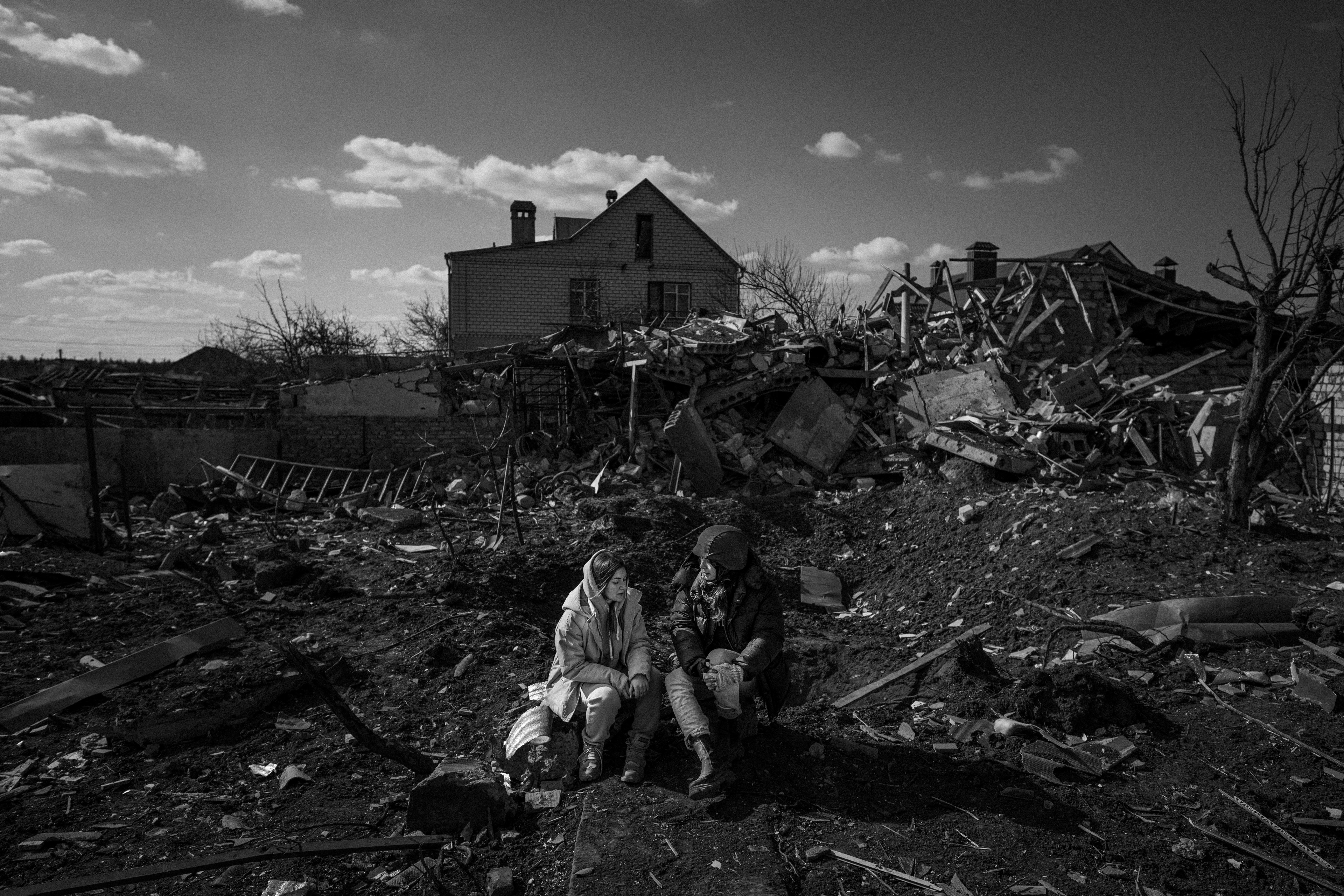 Isobel Yeung, reporting for VICE News Tonight, interviews a woman in front of a crater left by a Russian strike.