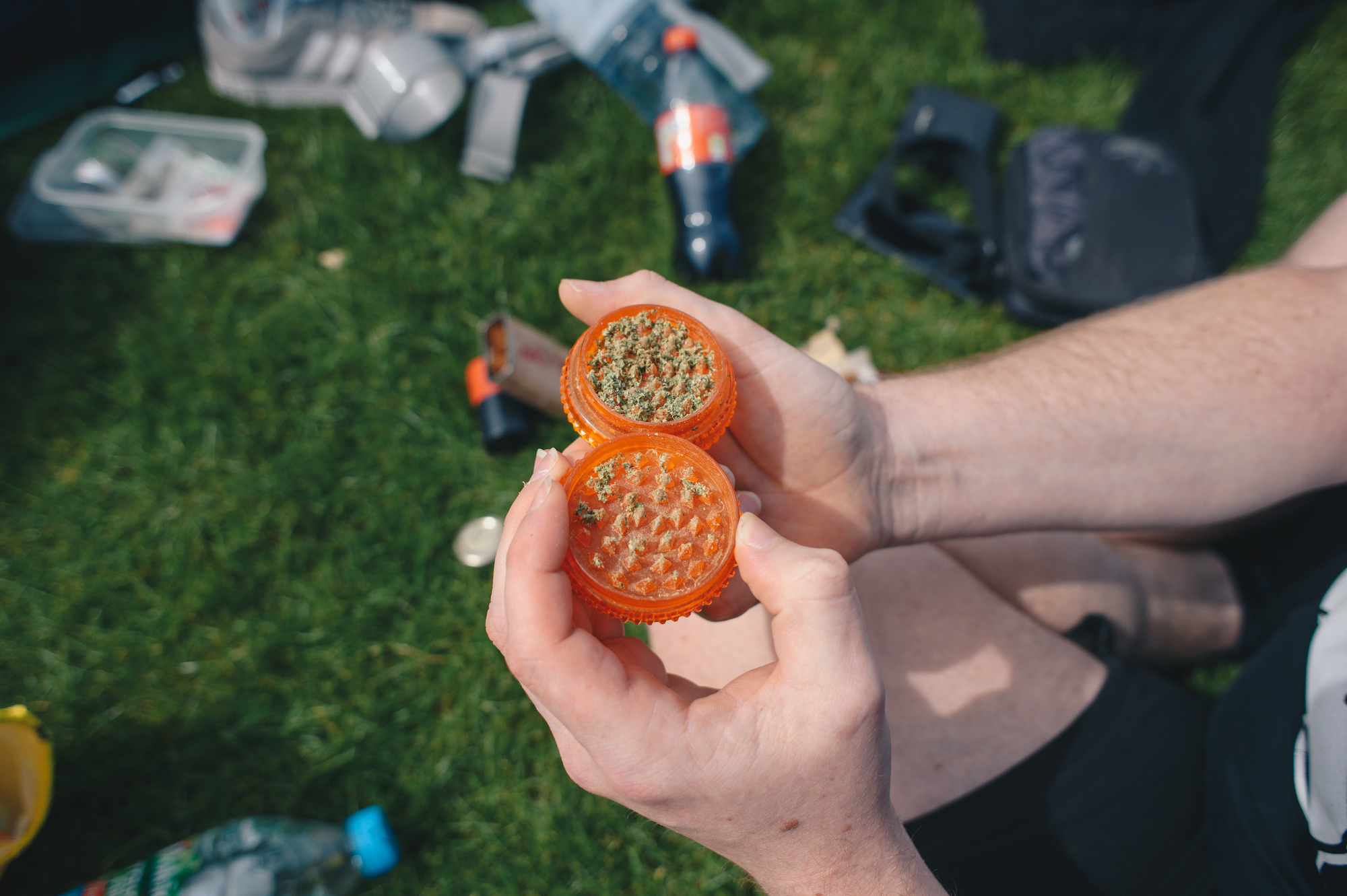 A person holds up a grinder full of weed at 4/20 protest in London Hyde Park