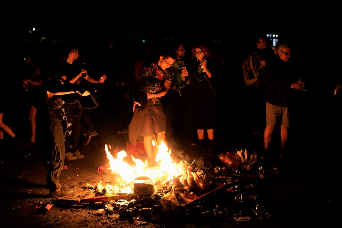Chile protests – people gathered around a bonfire.