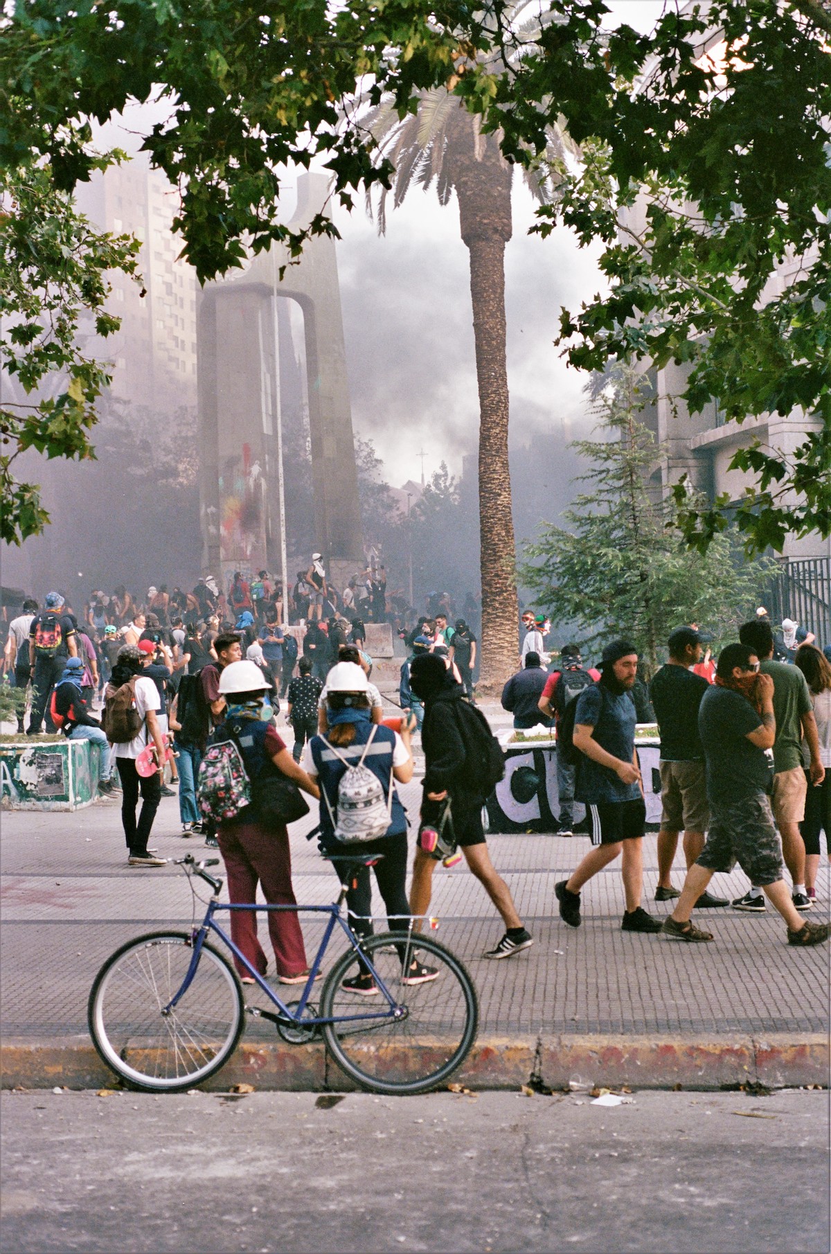 Chile protests – photos of people standing around a square. The air is thick and smokey from tear gas and small fires.