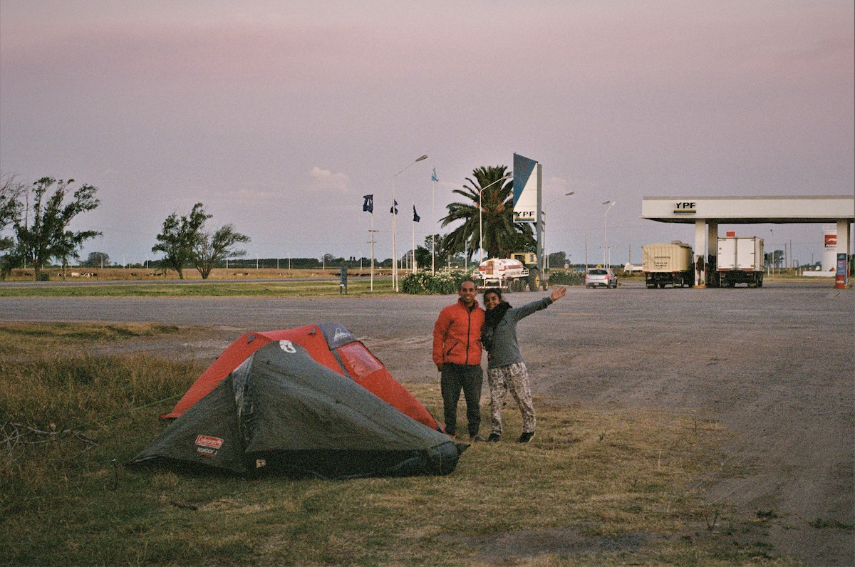 Chile protests – A couple standing next to a tent at a gas station.