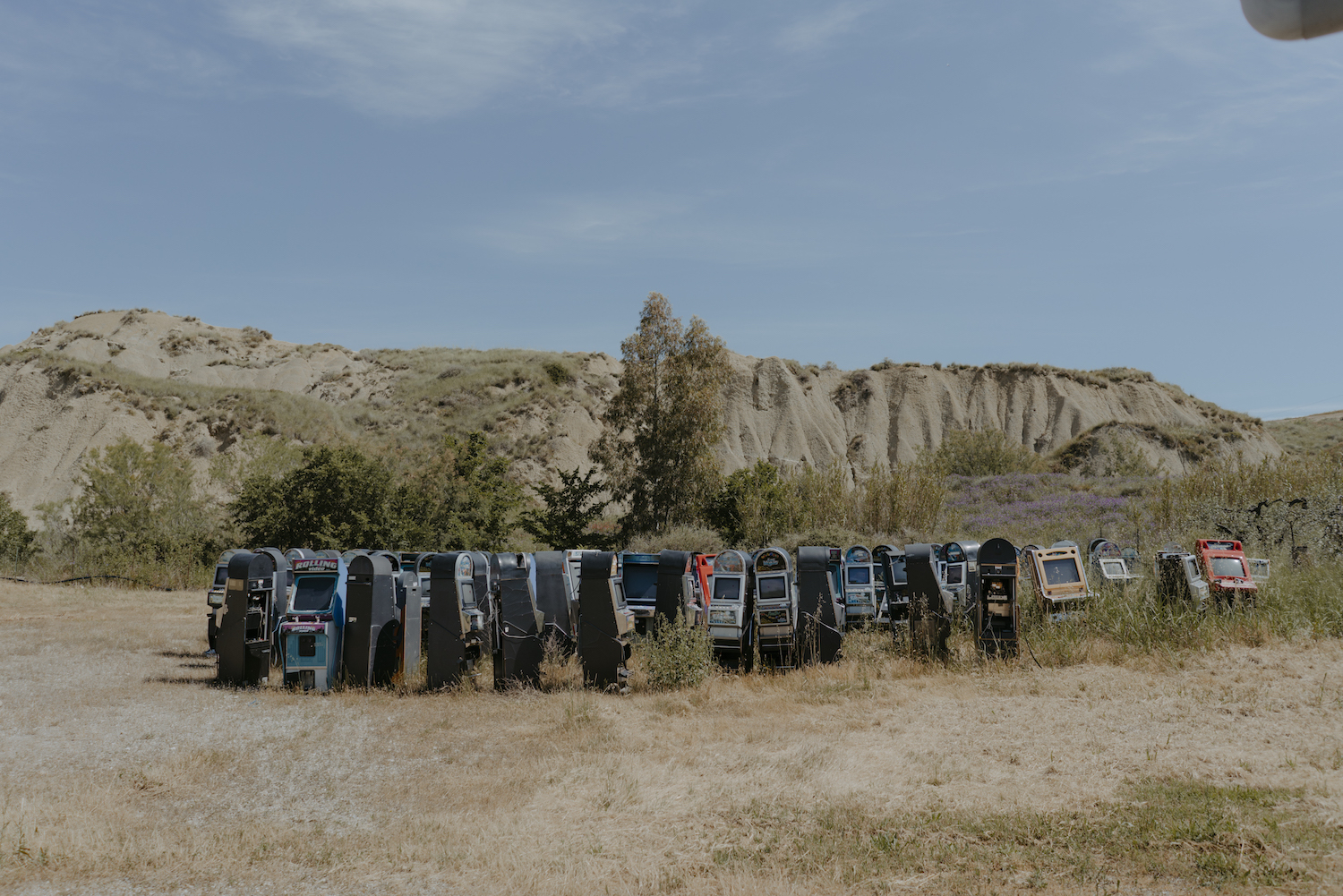 Michele Battilomo, De-population, Basilicata – a series of slot machines placed in a big circles in a semi-deserted area outside, in front of a small mountain.