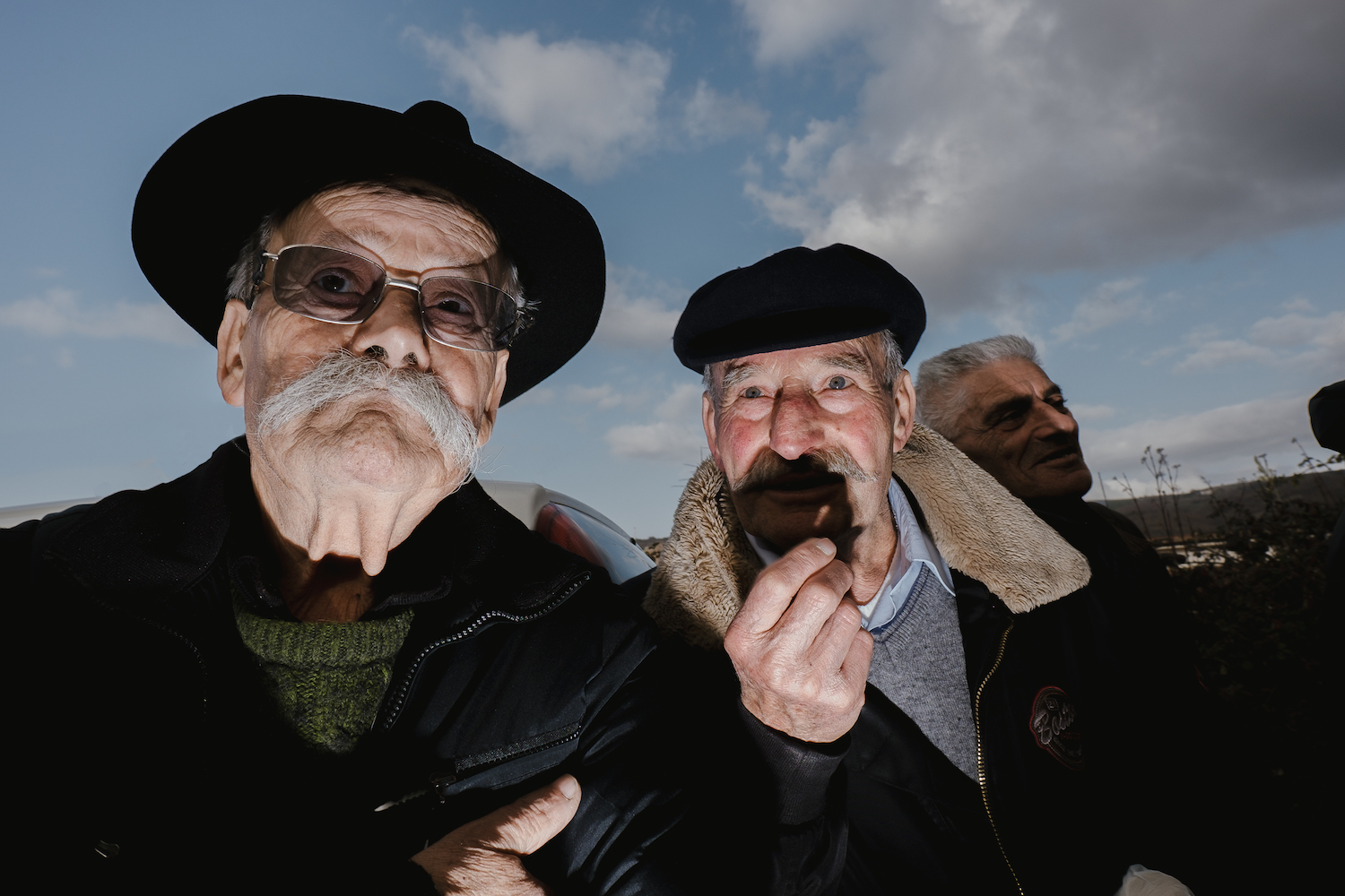 Michele Battilomo, De-population, Basilicata – close-up of two old men wearing hats and sporting full moustaches.