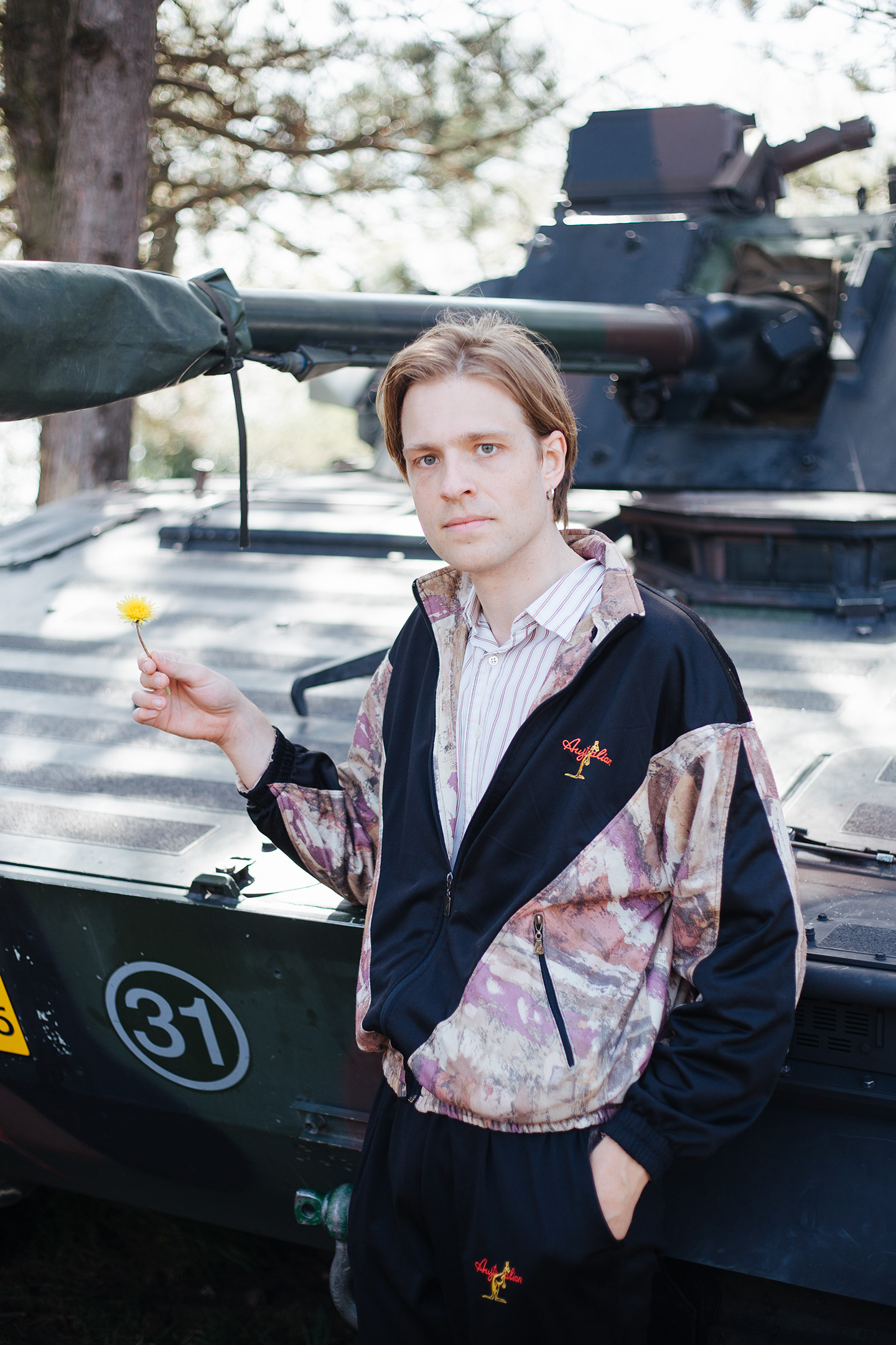 Army recruitment, Fort 1881 – The author posing with the tank and a yellow flower.