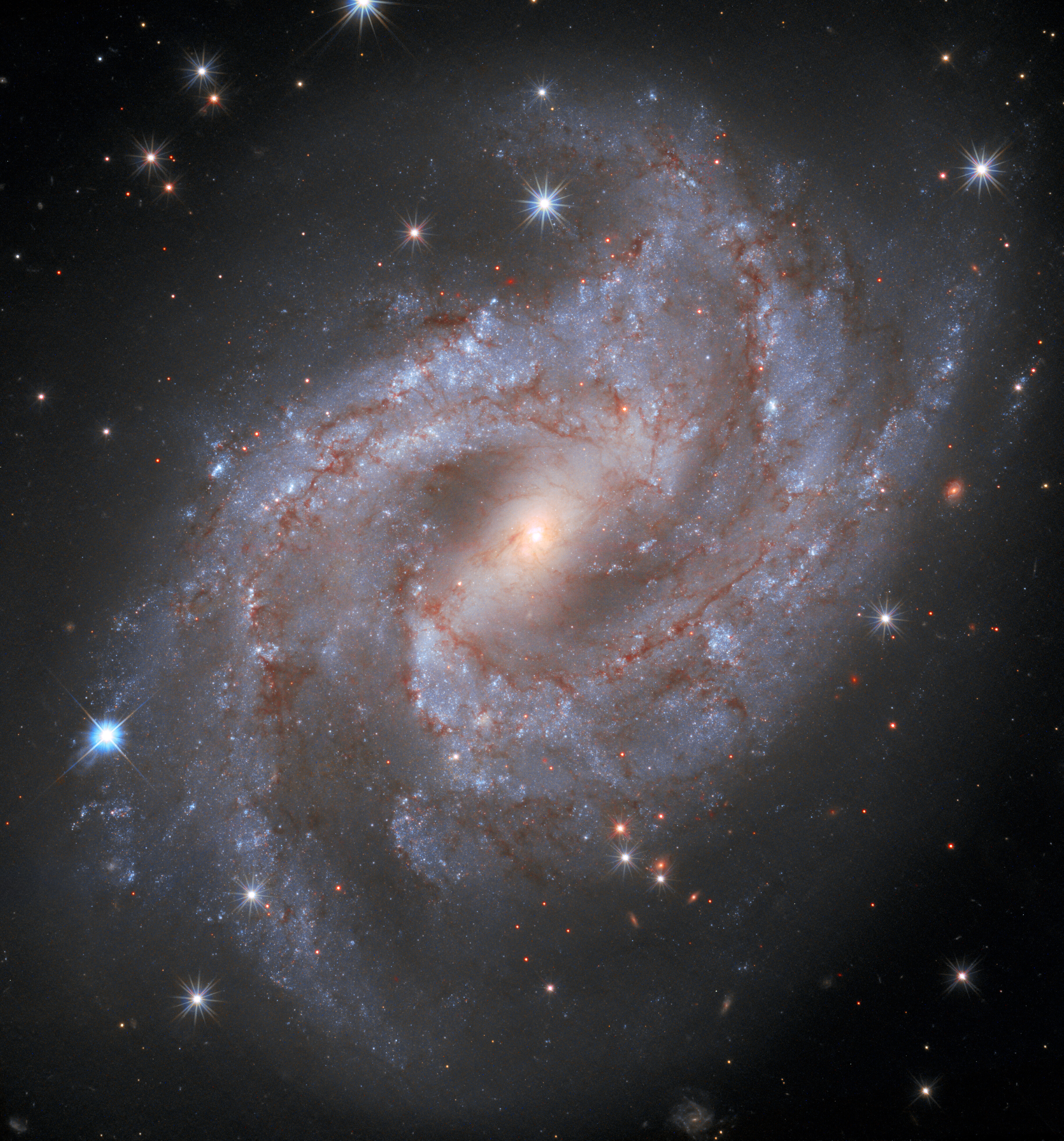ESA, Hubble Space Telescope, astronomy - Photograph of galaxy NFC 2525, white and red stars on a black background.