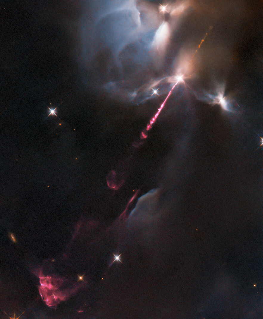 ESA, Hubble Space Telescope, astronomy - Image of pink gas being ejected from a young star in space.