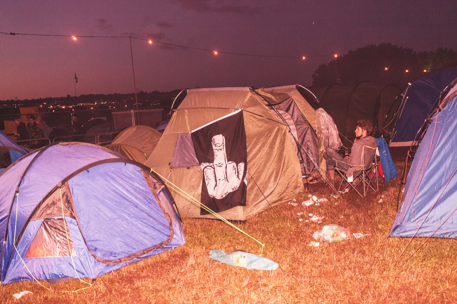 Someone's pitched tent at a music festival at night