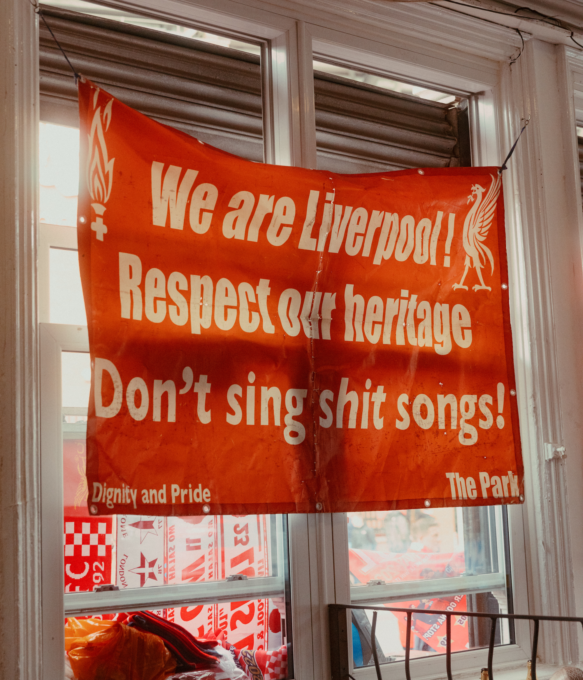 A sign in a Liverpool FC pub telling people not to sing shit songs
