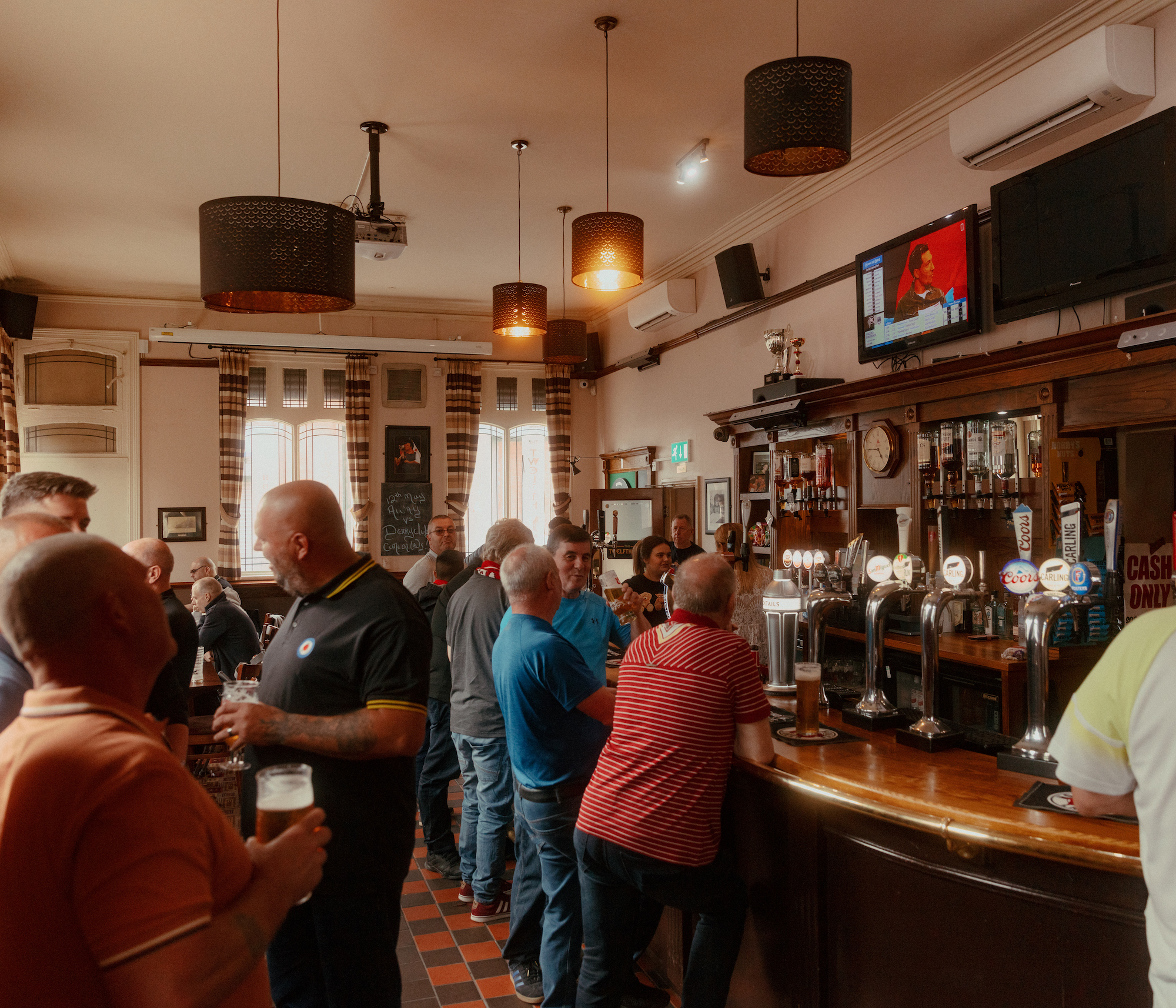 Fans watch TV in the Twelfth Man pub before kick off of Liverpool match