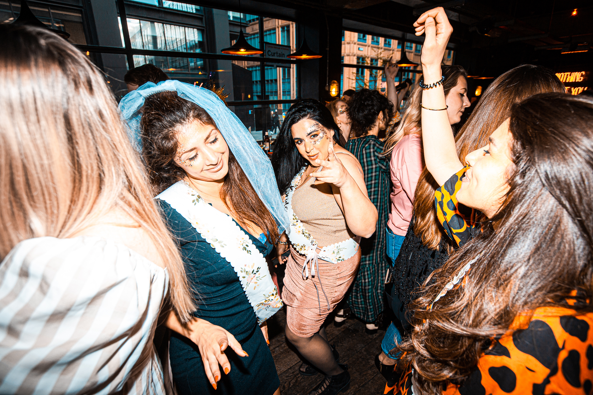 Women on a hen do dancing at the Queen of Hoxton drag brunch