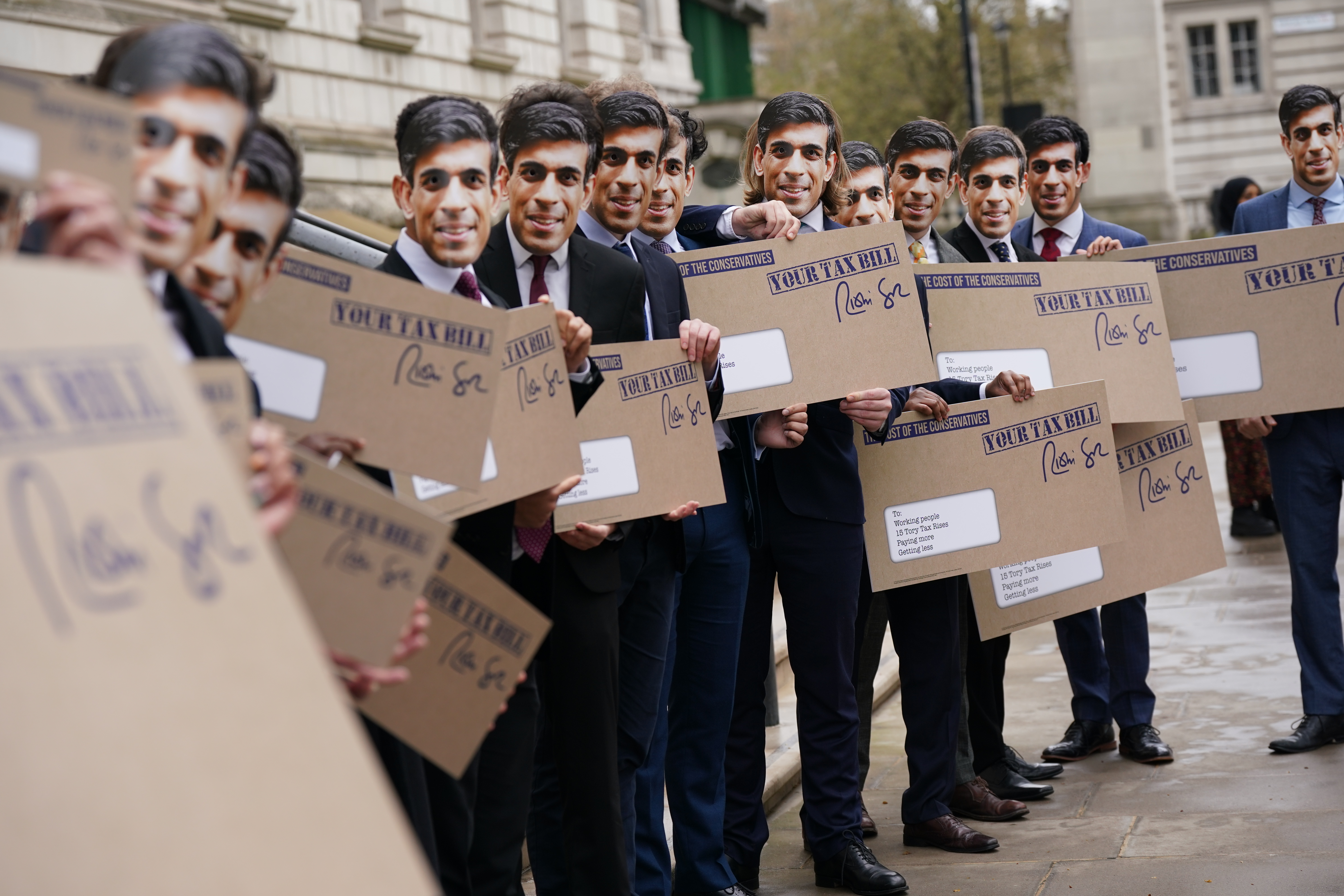 Campaigners dressed as UK Chancellor Rishi Sunak hold a protest outside the Treasury over a tax rise that they said would hurt low-earners more. Photo: Yui Mok/PA Images via Getty Images