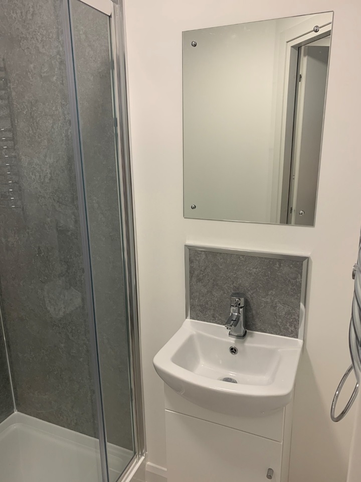 A bathroom with a tiny sink in a studio flat in Bristol